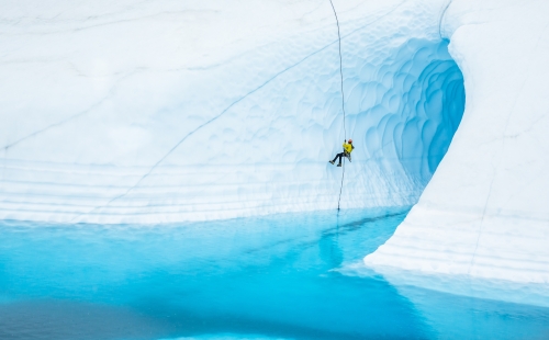 Person rappelling down a glacier